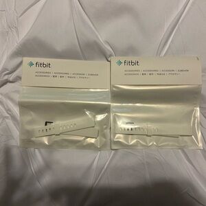 Two white fitbit watch bands